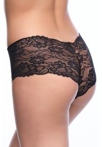 Le mutandine di pizzo nero presentano un motivo floreale, bordi ondulati e una texture elastica e trasparente. Il design offre una copertura moderata sul retro.