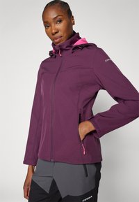 Giacca in pile di colore viola scuro con zip frontale, dettagli rosa, cappuccio regolabile e tasche laterali. Texture liscia e design slim fit.