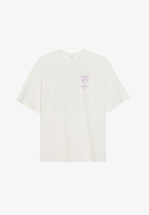Cream-colored t-shirt made of soft fabric featuring a purple palm tree graphic and "SUNSHINE CLUB" text on the front. Boxy fit, short sleeves.