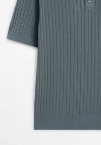 Polo à manches courtes gris côtelé avec patte de boutonnage. Caractérisé par un tissu texturé et des accents de couleur contrastante au col et à l'ourlet.