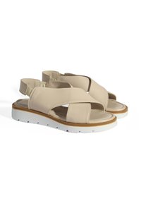 Beige lederen sandalen met gekruiste banden en een witte rubberen zool. Voorzien van een gevoerd voetbed en een verstelbare achterband.