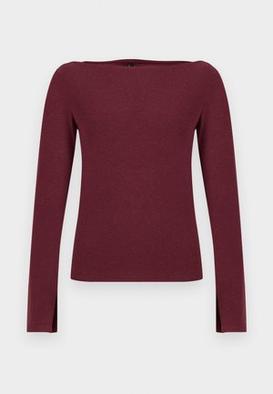 Bordo majica dugih rukava s broderama, izrađena od mekog materijala. Ima bočne proreze na rubu za lakše kretanje.