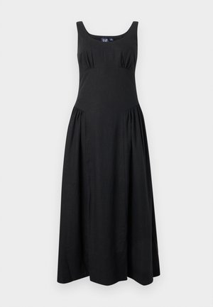 Μαύρο αμάνικο μάξι φόρεμα με βαθύ στρογγυλό ντεκολτέ και ρυτιδιασμένες λεπτομέρειες στο στήθος και τους γοφούς, κατασκευασμένο από ύφασμα με μείγμα λινό.