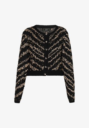 Cárdigan negro con un patrón de zigzag en color beige, adornado con cuentas doradas. Cuenta con botones en forma de corazón y un diseño corto con mangas largas.