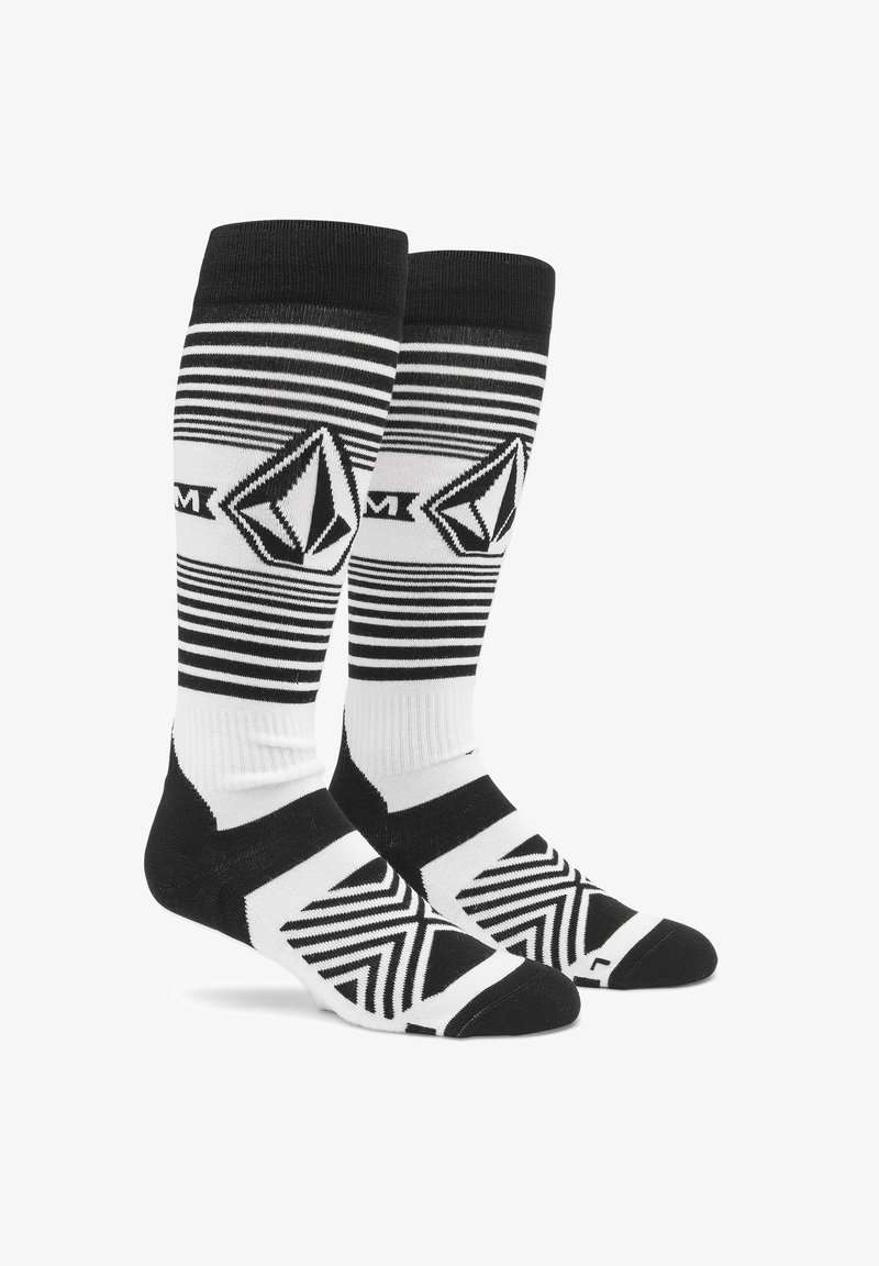 Knee-high socks in black and white with horizontal stripes, geometric patterns, and logo detail. Made from a blend of soft, durable materials.