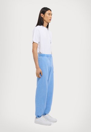 ICON UNISEX - Tracksuit bottoms - pigment blue