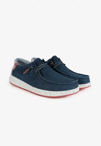 Navy blue shoes made of soft fabric with a textured pattern, featuring a speckled white and red sole, lace accent, and cushioned interior.
