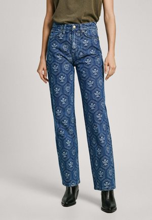 High-waisted blue jeans with an intricate floral and geometric pattern. Made from denim, featuring five pockets and gold-tone hardware.