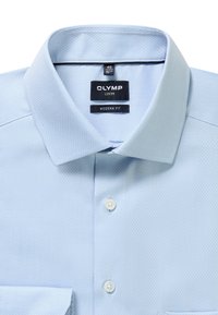 Light blue textured men's dress shirt with spread collar, two white buttons visible, and black labels reading "OLYMP Luxor Modern Fit."