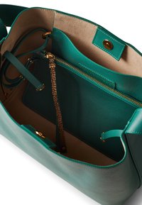 Teal leather handbag with a soft texture, featuring a beige interior, gold hardware, a zippered pocket, and a textured strap detail.