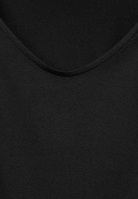 Black sleeveless top with a smooth texture and a rounded neckline, featuring a simple, clean design without additional patterns or accents.