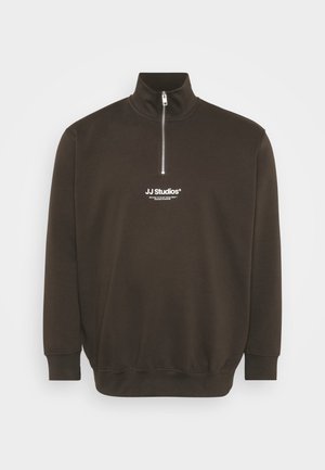 Dark brown sweatshirt with high collar and half-zip closure. Features logo in white on the chest and ribbed cuffs and hem. Soft texture.