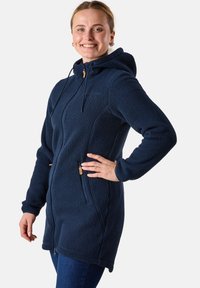 Navy blue fleece jacket with a hood, featuring two zippered pockets and adjustable drawstrings. Soft texture and mid-length design.