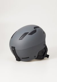 Gray ski helmet with a matte finish, featuring ventilation openings, textured bottom, and adjustable straps for secure fit.
