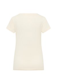 Camiseta de manga corta y cuello redondo en tejido beige claro con una textura suave. Diseño sencillo, sin patrones ni adornos visibles.
