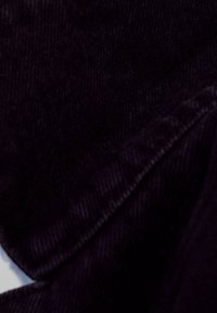 Dark denim fabric with a soft texture, featuring a subtle sheen. The material displays a classic twill pattern and clean edges.