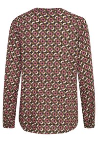 Langärmliges Oberteil mit einem blumigen Kreisdesign in Pink, Schwarz und Creme auf einem beigen Hintergrund, mit rundem Ausschnitt und geschwungenem Saum.