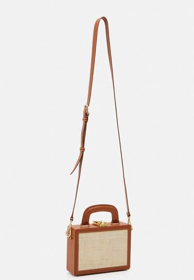 Brown leather handbag with a woven straw front, rectangular shape, short top handle, and adjustable shoulder strap with gold hardware accents.
