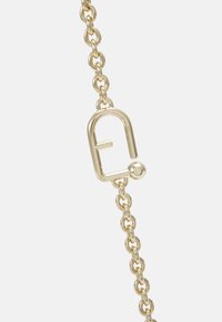 Gold metal chain with a lock-shaped clasp featuring a round ball detail. The chain consists of linked oval shapes, reflecting light.