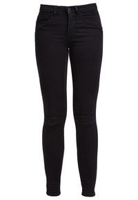Jean skinny noir en denim avec une texture lisse, comportant deux découpes usées au niveau des genoux et un design standard à cinq poches.