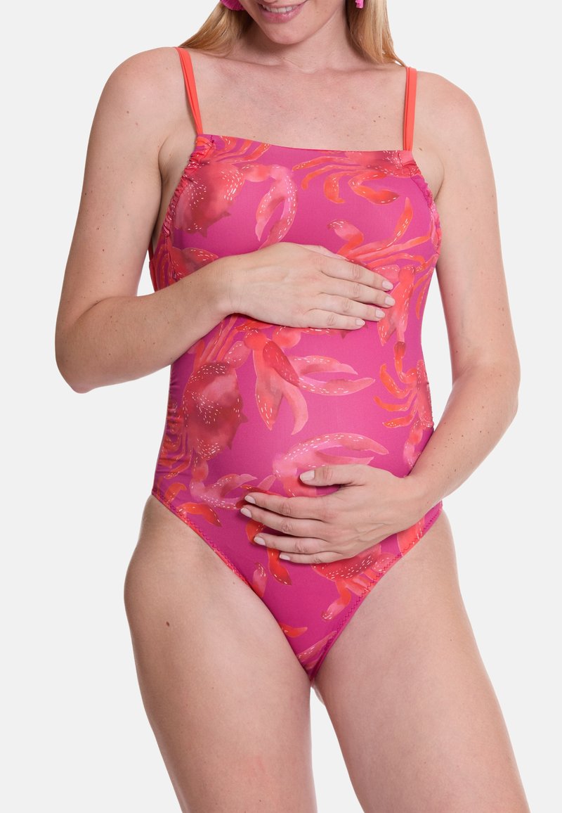 Roze eenpiece badpak met bloemenprint in tinten van rood. Bevat dunne bandjes en een aansluitend ontwerp, ideaal voor een strandsetting.