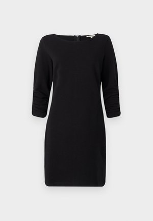 Vestido preto com mangas três quartos, decote arredondado, material texturizado e fechamento nas costas em zíper, oferecendo uma silhueta justa.