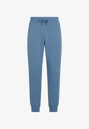 Pantalon de survêtement bleu en tissu doux, avec taille élastique dotée d'un cordon de serrage réglable, finitions côtelées aux poignets et détail de logo subtil.
