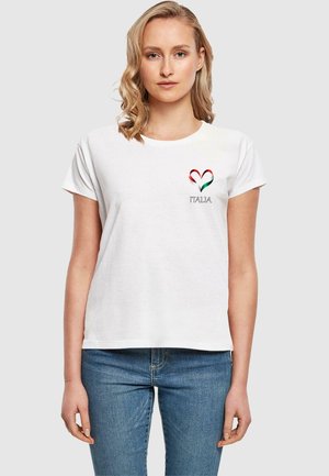 T-shirt en coton blanc à manches courtes, présentant un motif en forme de cœur rouge, vert et blanc avec le texte "ITALIA" imprimé en dessous.