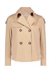 Vaaleanbeige kaksirivinen trench-coat, jossa on leveä kaulus, kaksi sivutaskua ja tummat napit. Takissa on myös olkapäät ja sileä pinta.