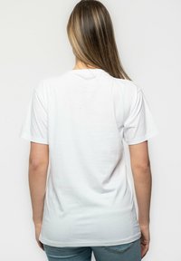 White cotton t-shirt with a crew neck and short sleeves, displaying a smooth texture and a relaxed fit. Back view shows no additional details.