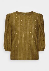 Blusa verde oliva con un design a maglia testurizzata, dotata di maniche a sbuffo e piccole aperture sparse per un tocco di dettaglio. Collo rotondo.