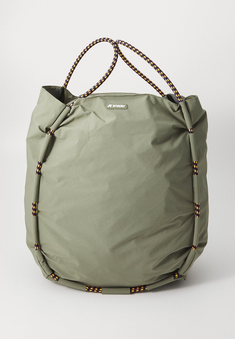 Green nylon tote bag with textured finish, featuring braided black and yellow handles and a central logo patch. Spacious and flexible design.