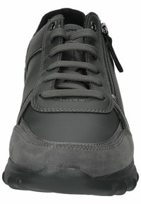 Chaussure de sport grise combinant cuir lisse et daim, avec lacets à l'avant, fermeture éclair latérale et semelle rembourrée. Design simple et fonctionnel.