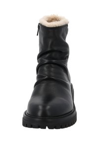 Stivaletto alla caviglia in pelle nera con interno in shearling, design morbido e cerniera laterale. Suola in gomma spessa con trazione. Semplice e funzionale.