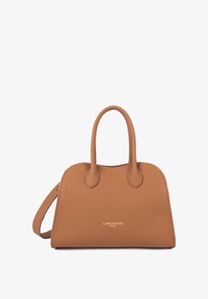 Tan leather Lancaster Paris handbag with two rounded handles and a detachable shoulder strap on a white background.