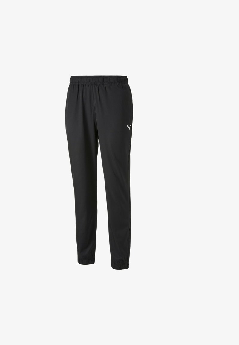 Zwarte sportbroek met een elastische tailleband, taps toelopende pijpen en gebundelde manchetten. Kenmerkt zich door een klein wit logo aan de linkerkant.
