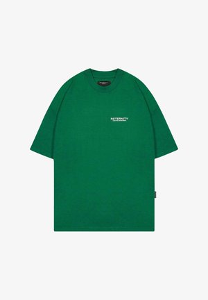 Zöld pamut póló laza fit, rövid ujjak, kerek nyakú, és fehér színű nyomtatott felirattal: "RETERNITY CREATIVE DEPARTMENT".