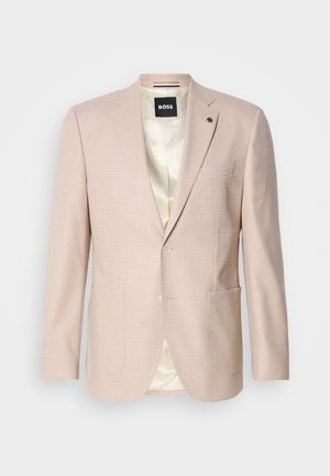 Vaaleanpunainen bleiseri, jossa on hienovarainen ruutukuosi. Varustettu nokkahuppua, kahdella etutaskulla ja yhdellä napilla suljettavaksi. Vuorattu sisus.