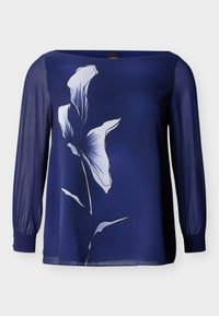 Μπλούζα μακρυμάνικη σε ναυτικό μπλε με διαφανή μανίκια και μεγάλο λευκό floral μοτίβο στο μπροστινό μέρος.