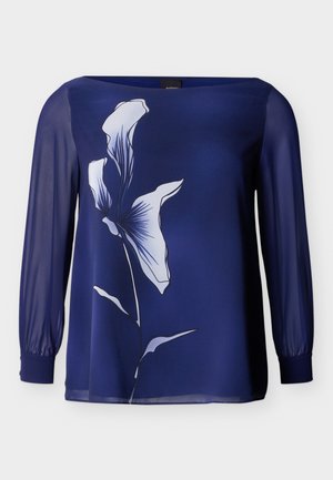 Μπλούζα μακρυμάνικη σε ναυτικό μπλε με διαφανή μανίκια και μεγάλο λευκό floral μοτίβο στο μπροστινό μέρος.