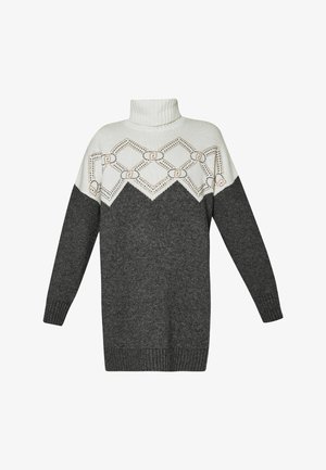 Maglione a collo alto con una sezione superiore bianca decorata da un motivo geometrico, che sfuma in grigio scuro, con polsini e orlo a costine.
