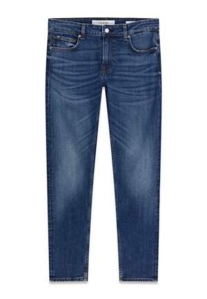 Jean denim slim-fit bleu pour homme avec poches avant, passants pour ceinture et détails délavés, estampillé d’une étiquette Guess à la ceinture.