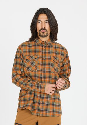 Chemise à carreaux dans des tons orange, vert et noir ; dotée de deux poches poitrine, d'un col à boutonnière et de manches longues. Fabriquée en tissu épais.
