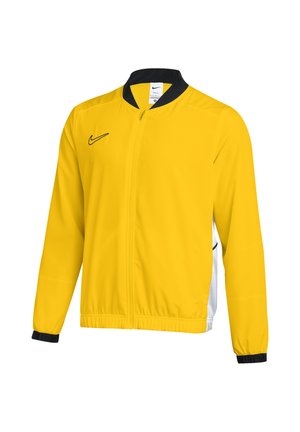 Gelbe Sportjacke mit durchgehendem Reißverschluss, schwarzem Kragen, schwarzen Ärmelbündchen und schwarzem Nike-Logo auf der Brust, plus weiße Seitenteile.