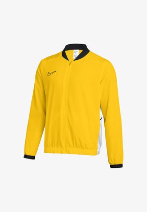 Gelbe Sportjacke mit durchgehendem Reißverschluss, schwarzem Kragen, schwarzen Ärmelbündchen und schwarzem Nike-Logo auf der Brust, plus weiße Seitenteile.