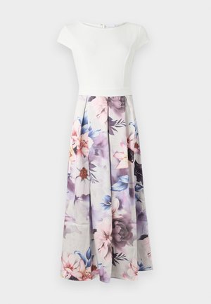 Hvid kortærmet kjole med tætsiddende bodice og en flydende skørt med blomsterprint i pastelfarver, der har frynser og lynlås bagpå.