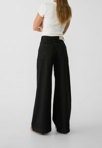 Stradivarius Jeans a zampa - black denim