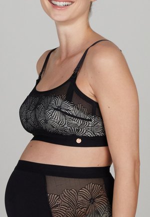Zwarte voedingsbeha met kantdetails en meshpanelen, verstelbare bandjes en een klein metalen accent. Zacht, rekbaar materiaal voor comfort.