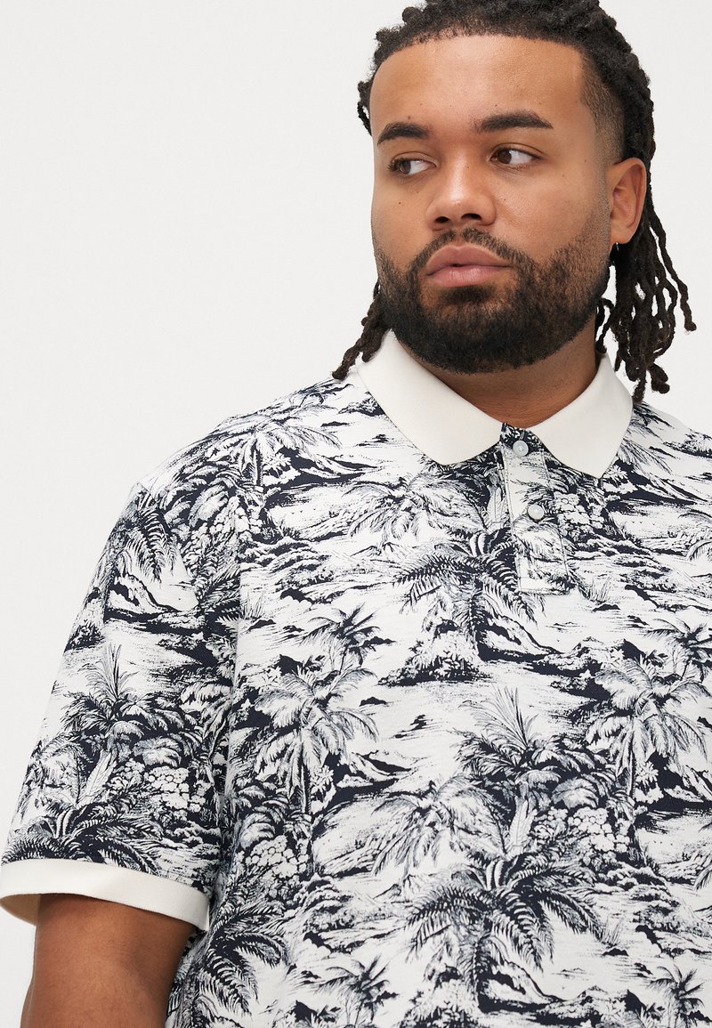 Kurzärmeliges Poloshirt in Weiß mit schwarzem tropischem Palmenmuster, mit kontrastierendem weißem Kragen und Knopfleiste.