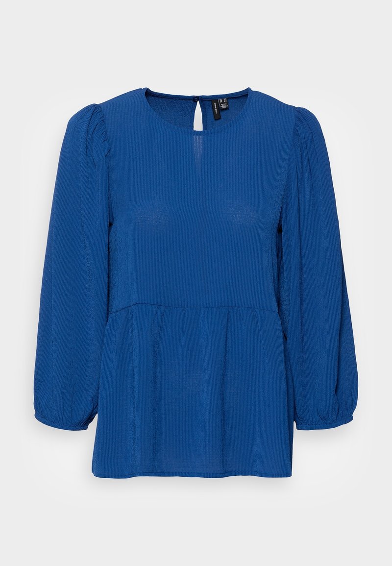 Haut texturé bleu avec un col rond, de longues manches bouffantes et un dos avec une découpe en clé. Présente un corsage ajusté et un ourlet évasé.